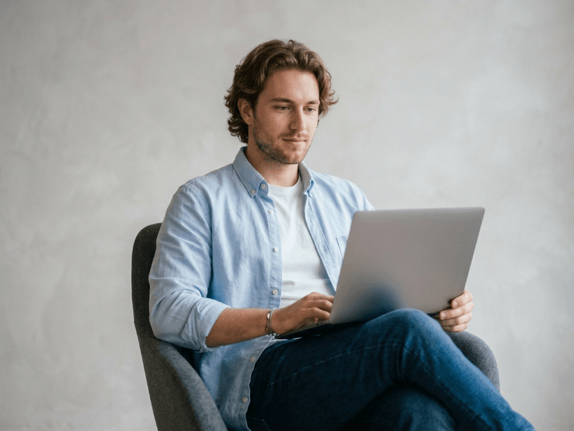 Man sitting and working on a laptop.